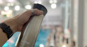 someone holding a coffee tumbler