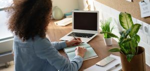 woman typing on her computer